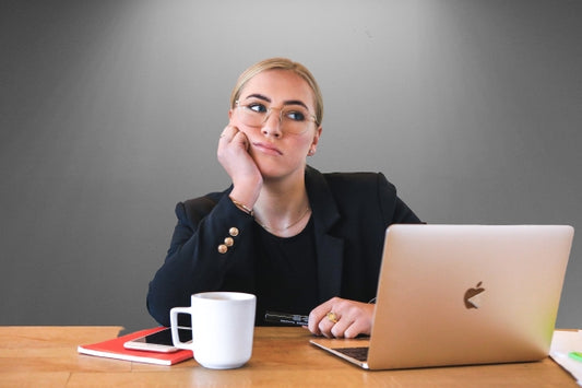 woman feeling tired in from of a computer