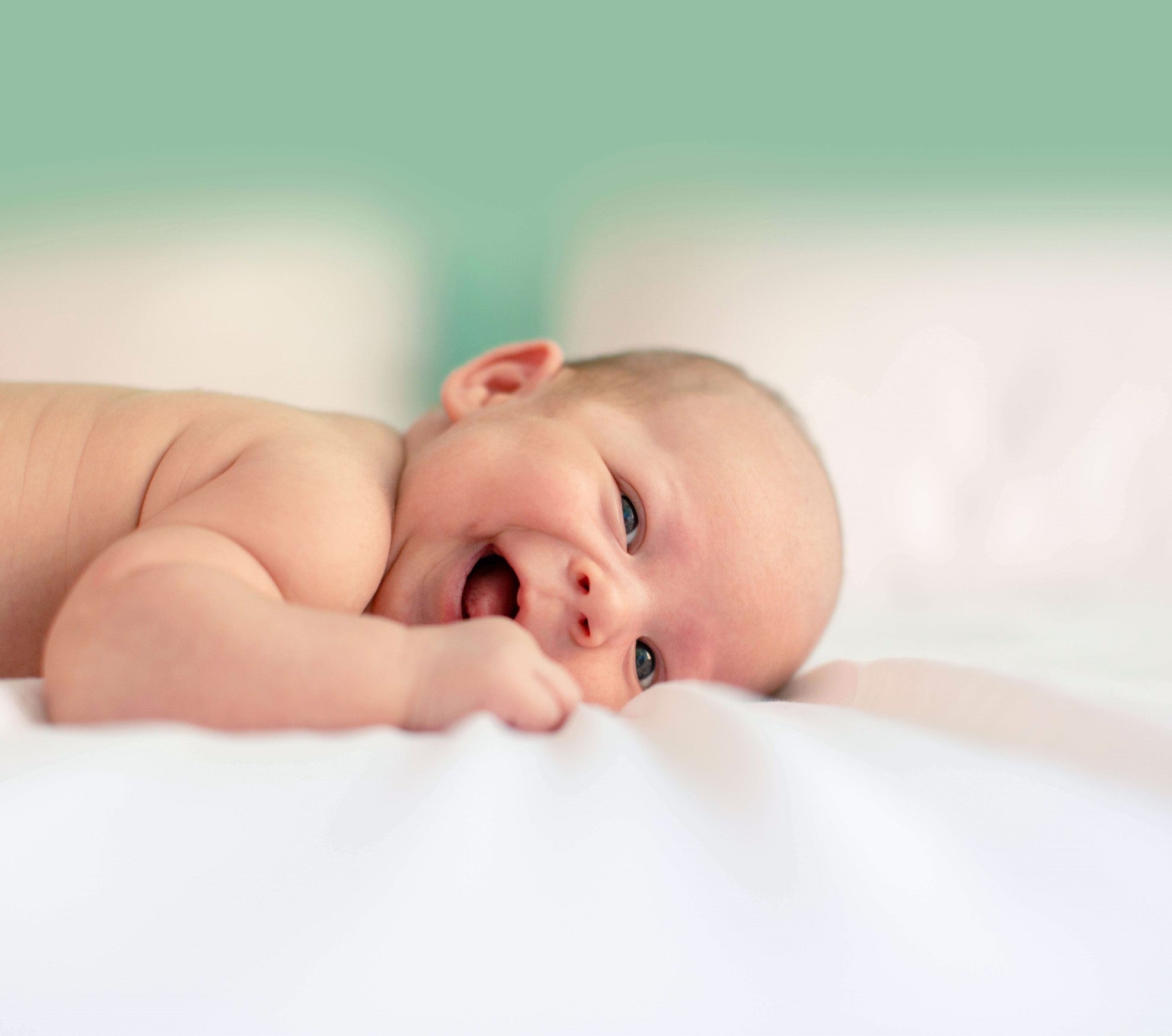 happy baby sleeping on bamboo sheets