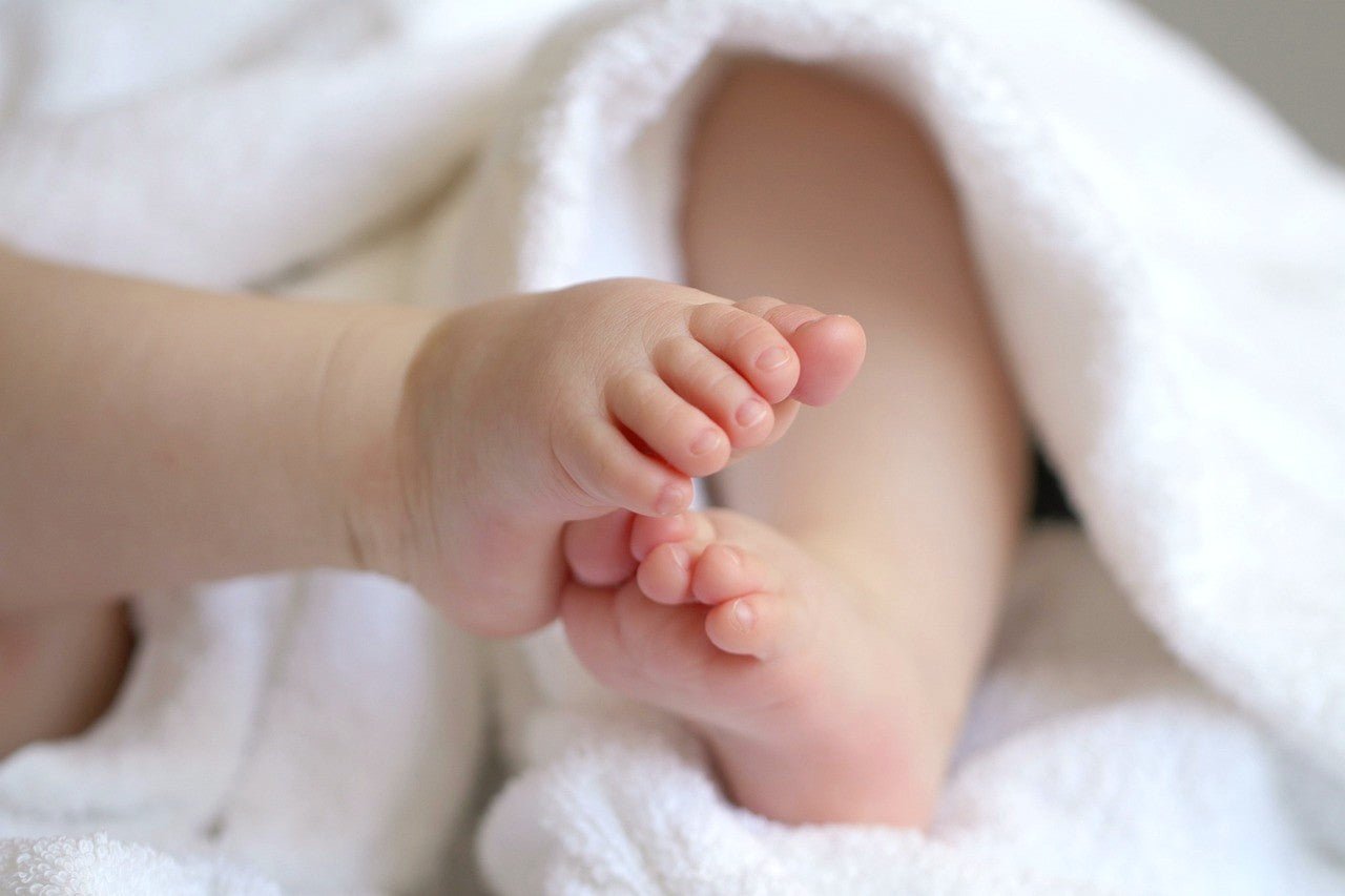 baby feet snuggle in soft bamboo blanket
