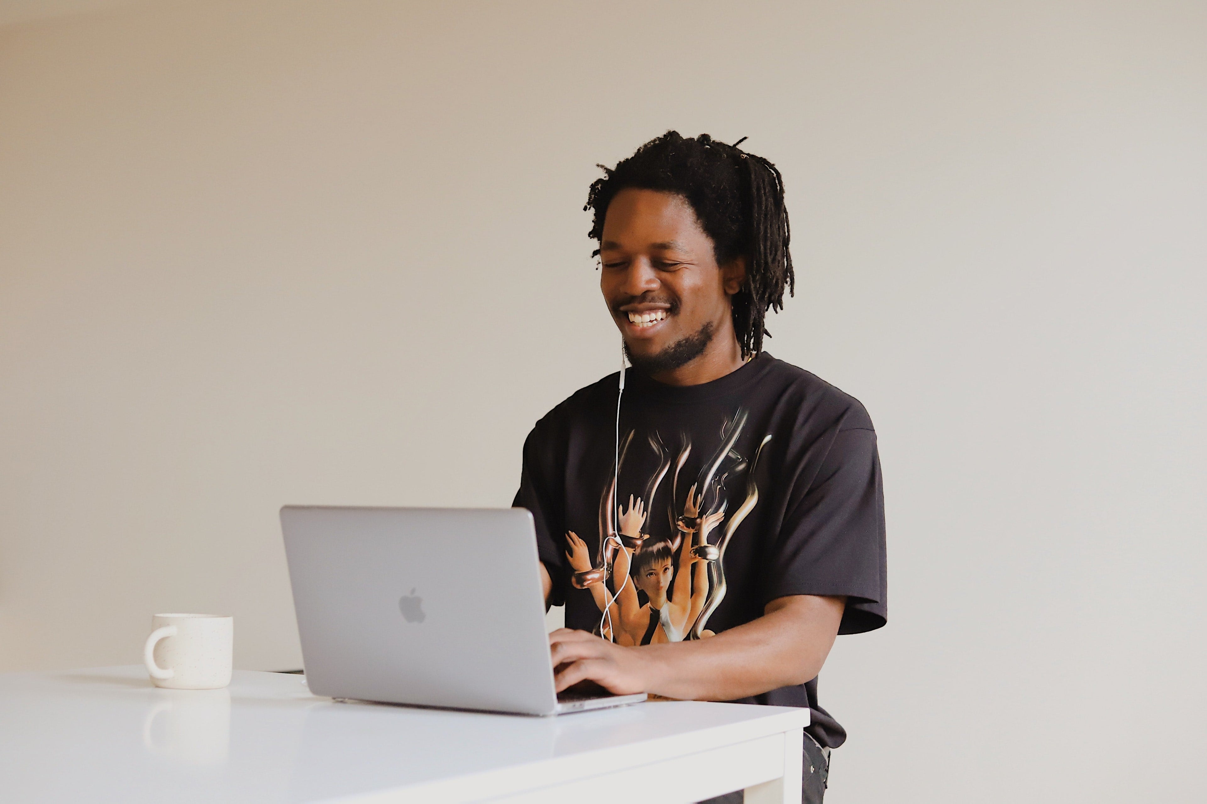 a man is pre-ordering online and looks happy to be saving on organic bed sheets and pillows