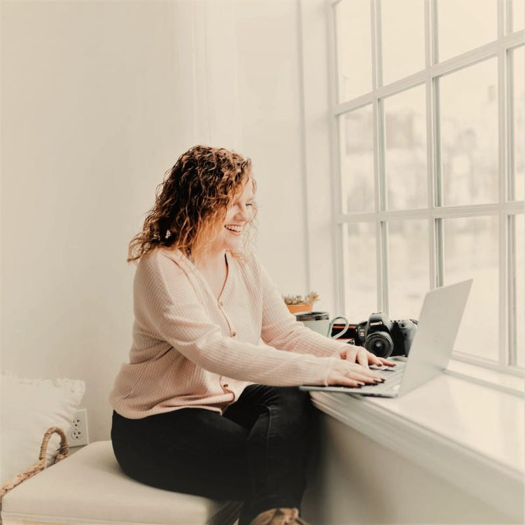 a woman is pre-ordering online and looks happy to be saving on organic bed sheets and pillows