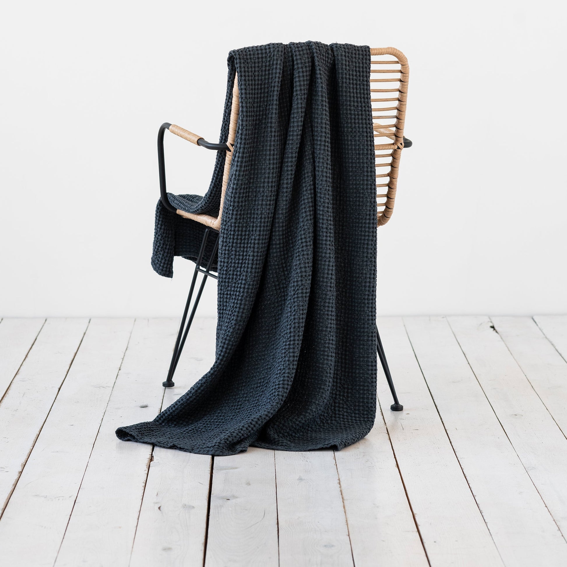 dark charcoal flax linen throw blanket on a chair